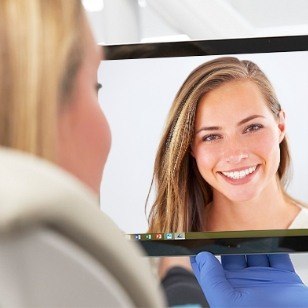 Woman talking to dentist over video call on tablet screen