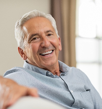 man smiling after getting dental implants in Richmond