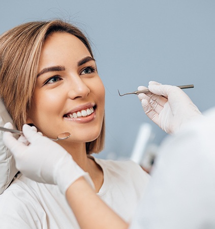 Patient smiling at dentist during dental bonding appointment