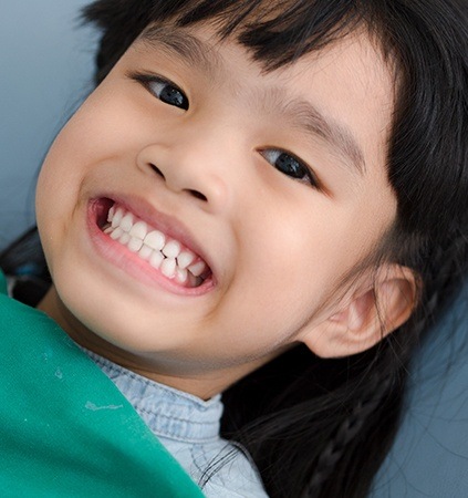 Child smiling after silver diamine fluoride treatment