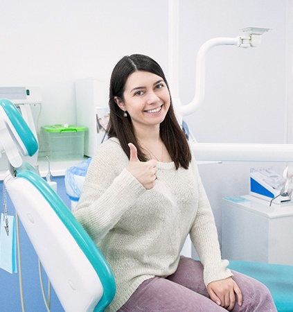 Female patient giving thumbs up after cosmetic dentistry in Richmond, VA