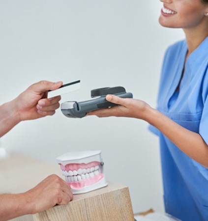 : a patient paying their dentist