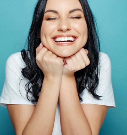 woman smiling with her eyes closed