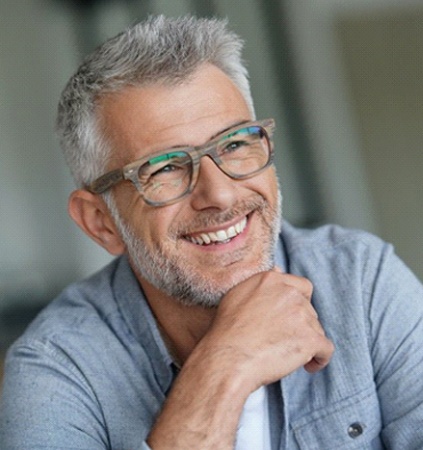 gray-haired man with dentures smiling
