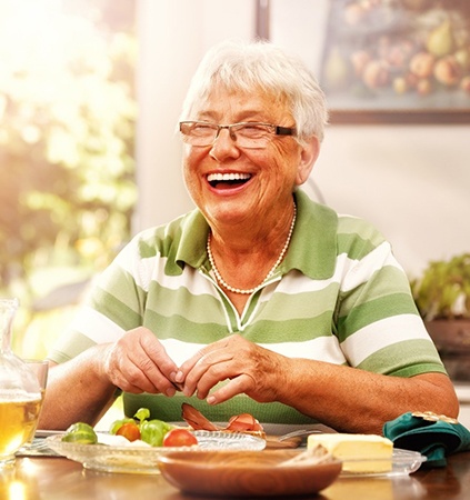 Senior woman smiling with dentures in Richmond