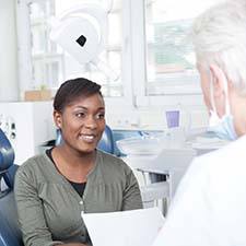 Patient and dentist discuss how to pay for emergency dental care in Richmond