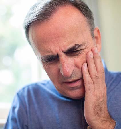 Pained man with questions for his Richmond emergency dentist 