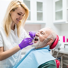 dental hygienist giving a patient a teeth cleaning