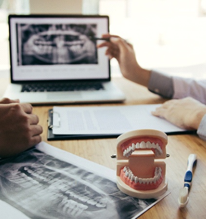 Implant dentist in Patterson speaking with a patient