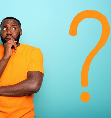 Man with orange question mark wonders about dental implants in Richmond