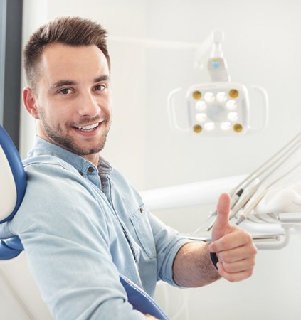 Man with missing tooth looking at tooth shade options