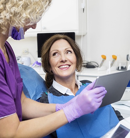 dentist showing a patient a tablet
