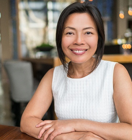 woman sitting at a table in a coffee shop