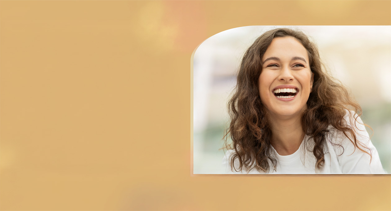 A woman smiling broadly with her mouth open, conveying joy and happiness