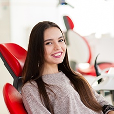 Closeup of teen smiling while sitting in dental chair