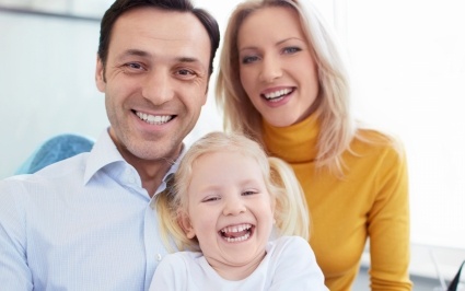 Family of three in dental office for preventive dentistry visit