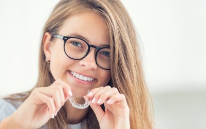Young woman placing Invisalign tray
