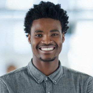Young man in gray shirt smiling