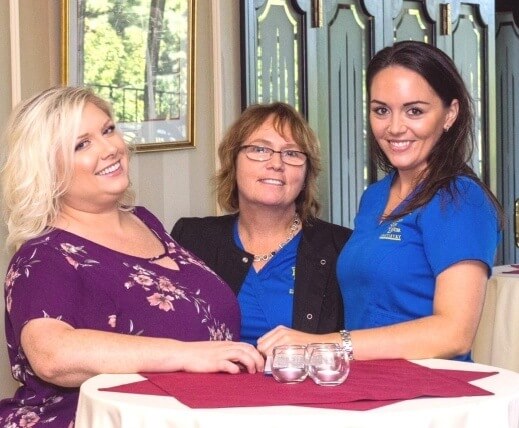 Three Richmond dental team members sitting at table