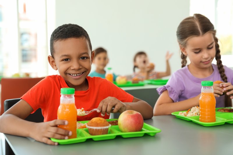 Kids in cafeteria eating school lunches