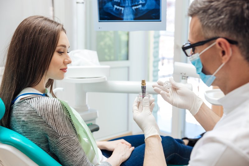 patient learning about dental implants in Richmond