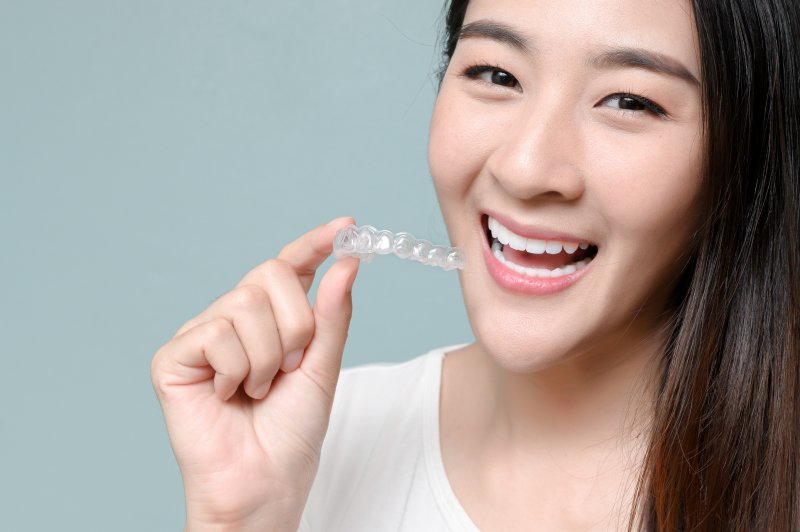 person holding Invisalign